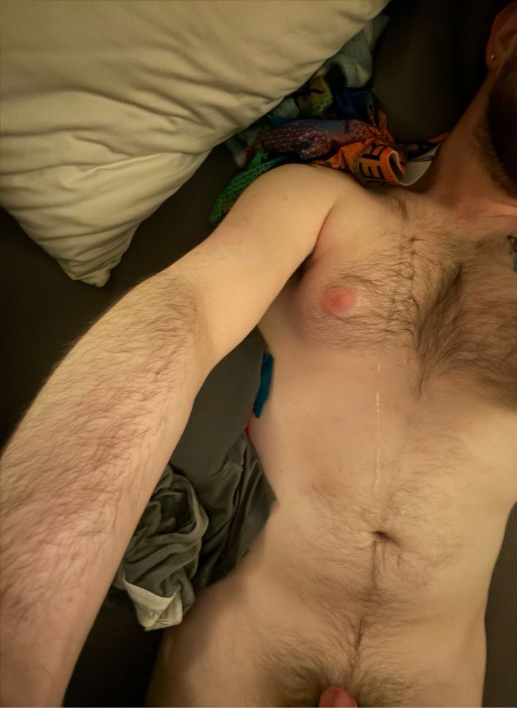 My furry torso. Tip of my dick visible. A few steaks of cum are visible, spanning from my belly button to the top of my shoulder. 