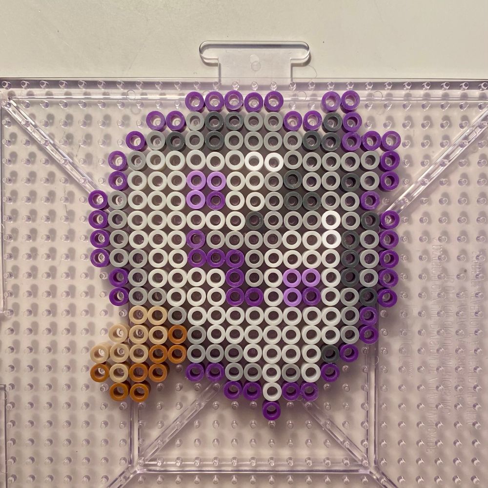 A design of a seal character made of perler beads in the shape of a cute popsicle.