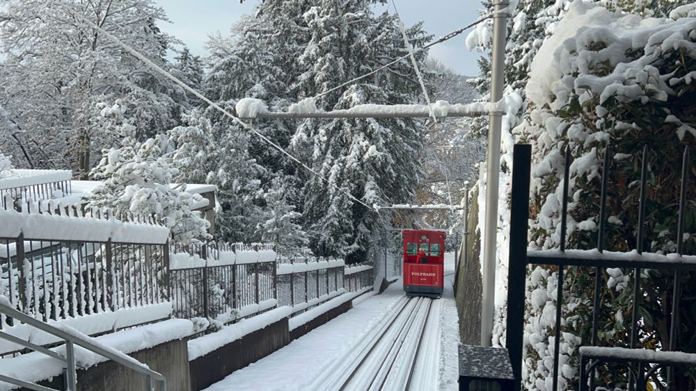 Polybahn cable car going down a snowy hill