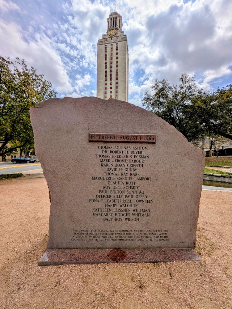Historical marker listing the date August 1st 1966 and victims' names of the UT Tower shooting. The Tower stands in the distance behind the marker.