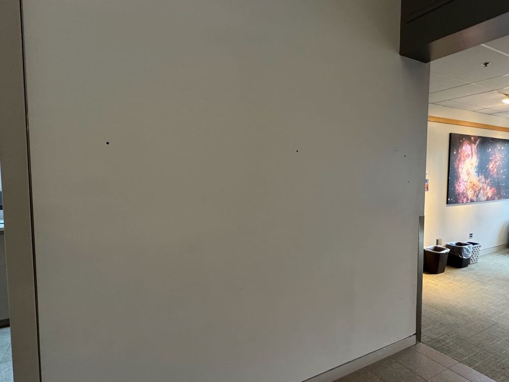 Blank wall after plaque has been removed, presumably reflecting an underlying change in values.