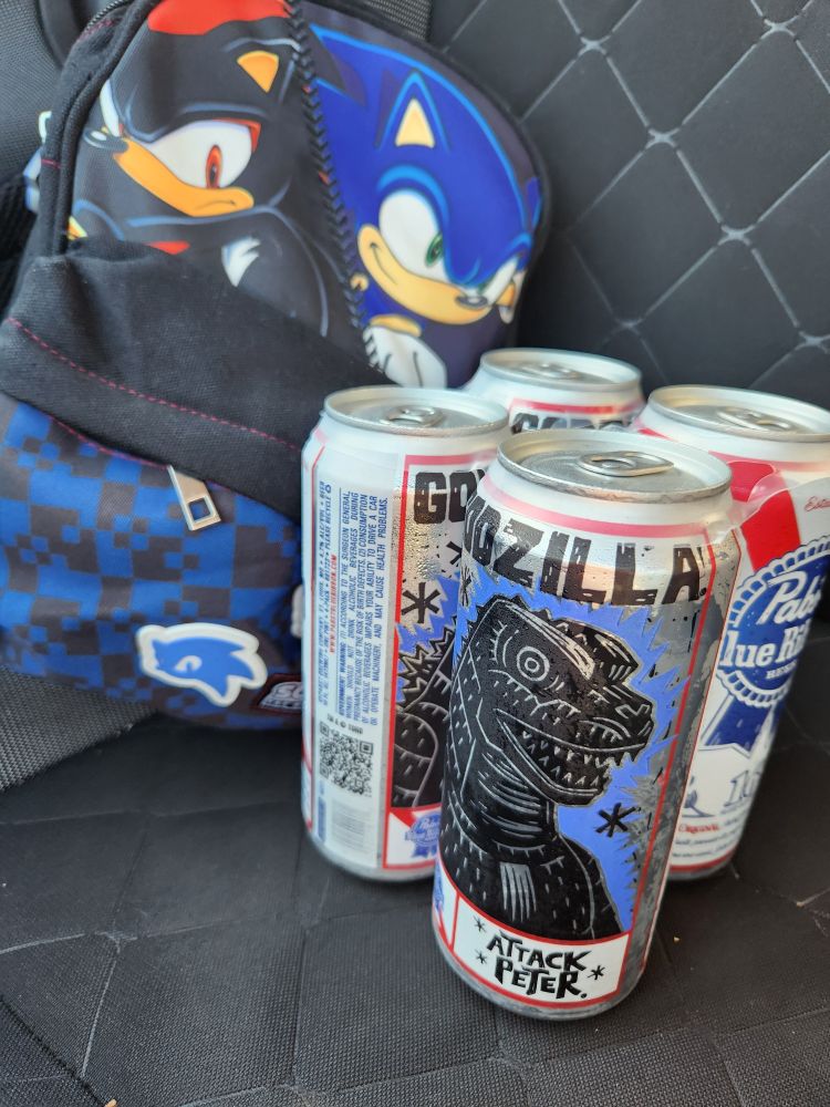 pabst blue ribbon beer with godzilla art on it