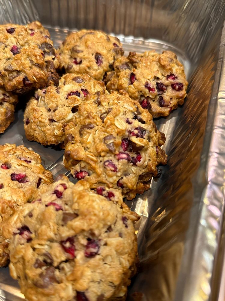 A close up of some pomegranate chocolate chip cookies in a baking tray.