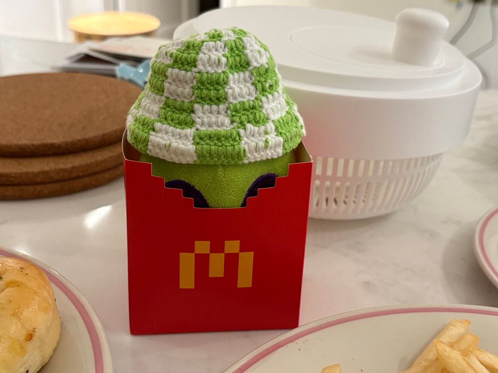 alien plushie sitting in a Minecraft themed McDonald's fry box

