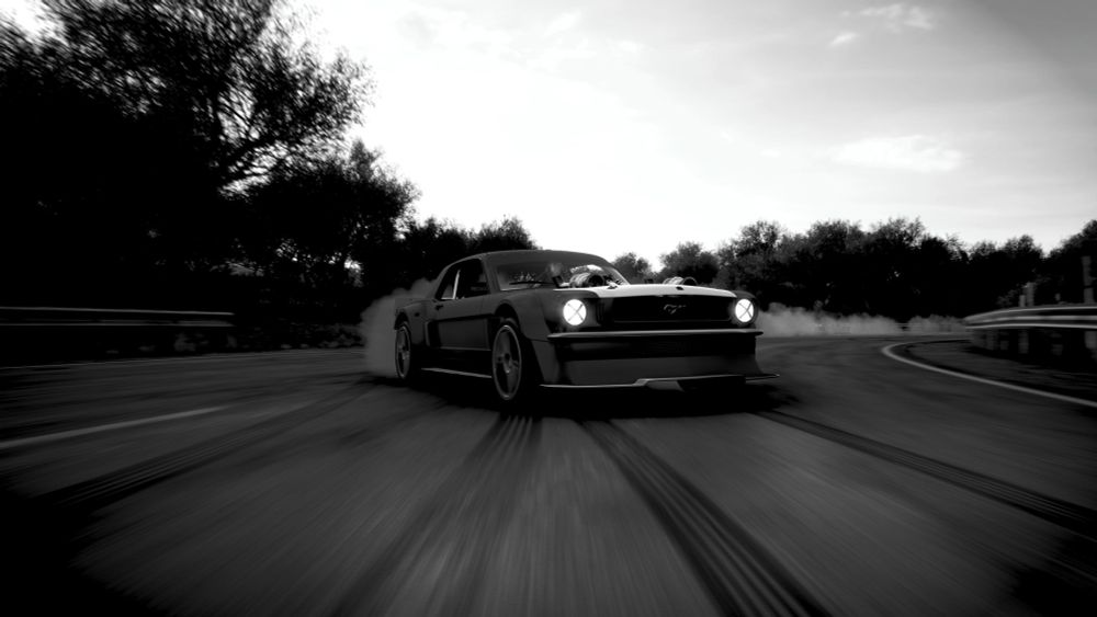 a black and white picture of a mustang drifting
