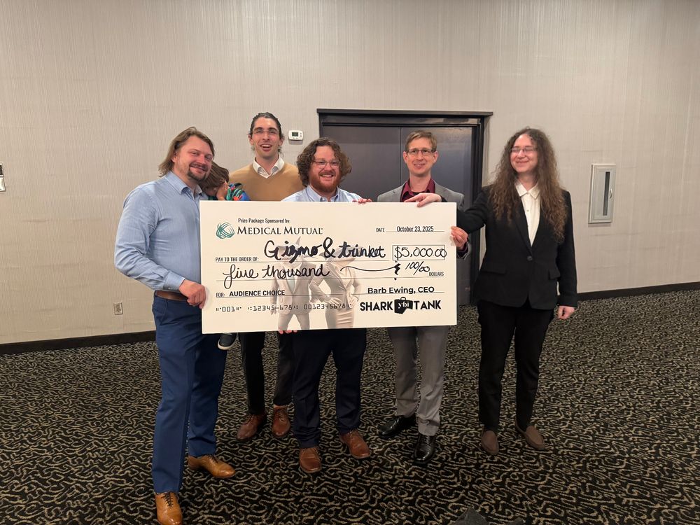 A picture of Jane, Nick, Ben, Jeff, and Drew holding a huge check for $5000