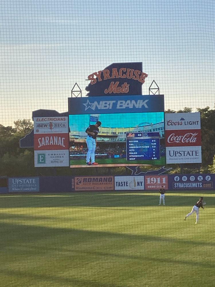 Kodai Senga throwing warm up pitches on the Syracuse Mets scoreboard