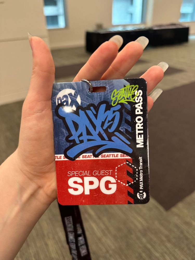 Pax 25 badge. The top half of the badge is blue with the text “Pax25” and the lower half is red and says “special guest SPG” 