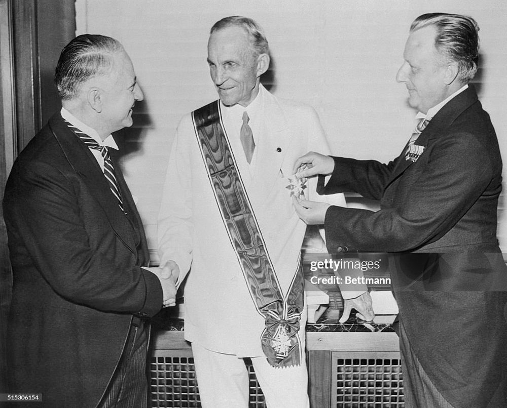 Henry Ford on his 75th birthday being given the medal by Nazi officials 