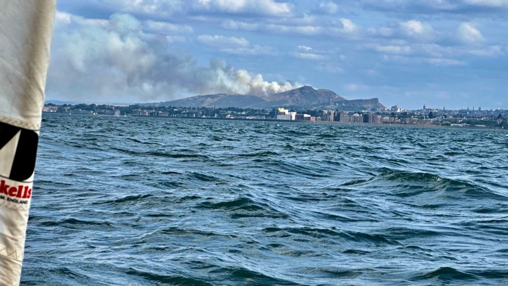 View from Dinghy on the Forth of smoke billowing from Arthur’s Seat. 