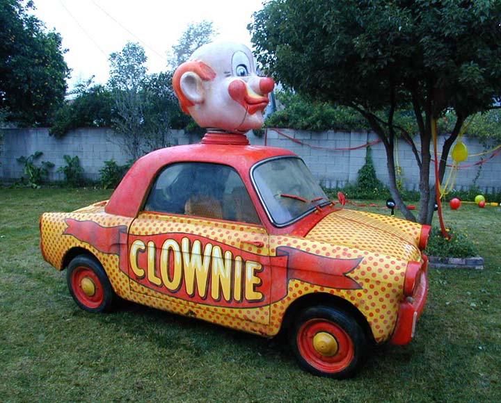 A car with "CLOWNIE" displayed on the side and a clown mascot head attached to the roof.