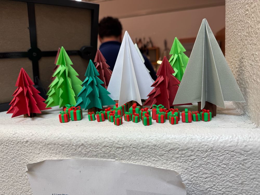 more paper trees (some are red) and more presents 