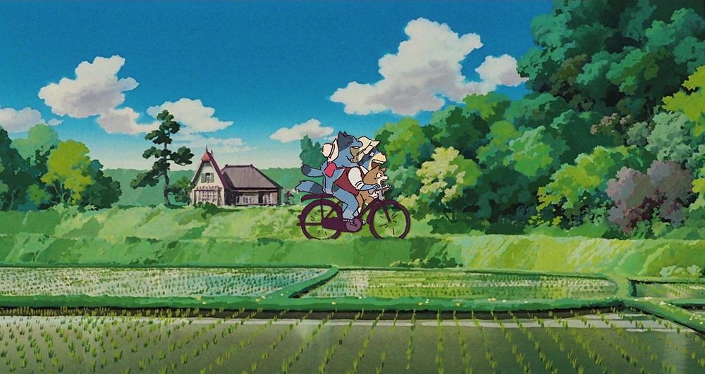 an altered/edited screenshot of Studio Ghibli's Totoro, where instead of sister Sasuki and Mei, it's a ghibli-style Bluey and Bingo. In this instance it's the scene where they and their father ride a bicycle to meet their mother