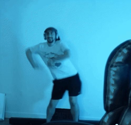 a blurry picture of a man wearing headphones dancing