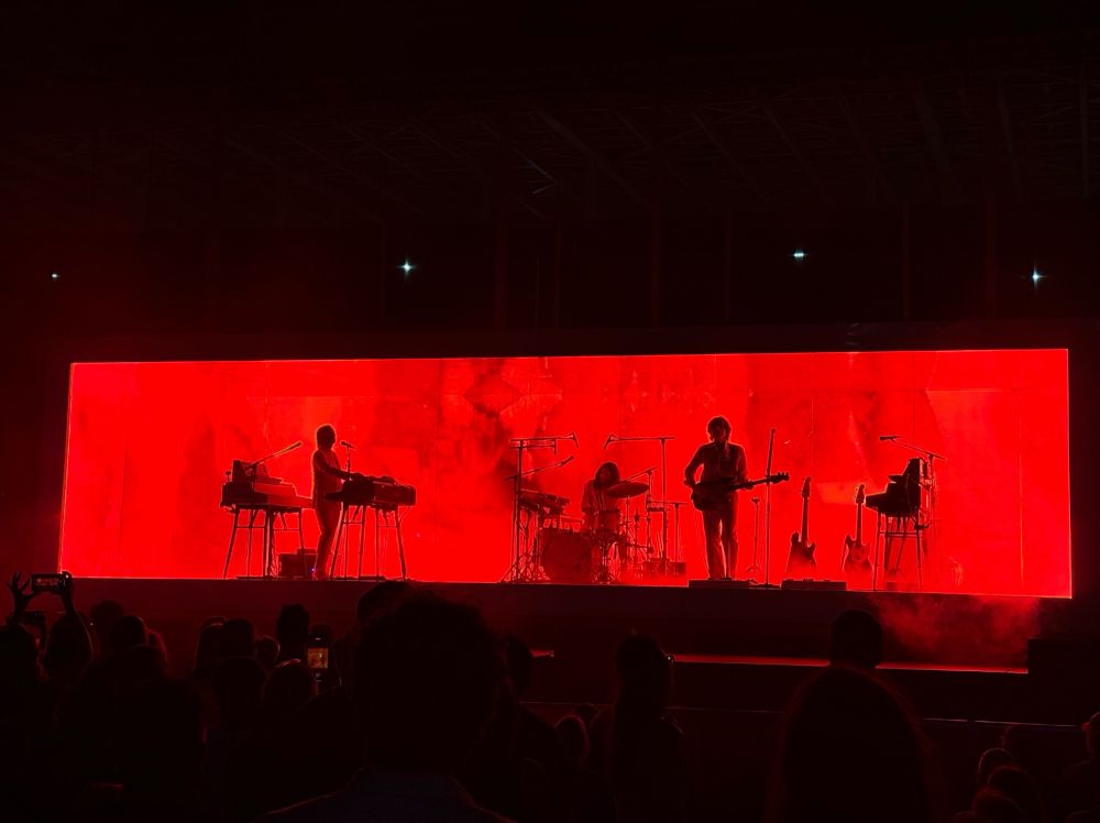 The band AIR, playing if front of screens showing spreading red stains