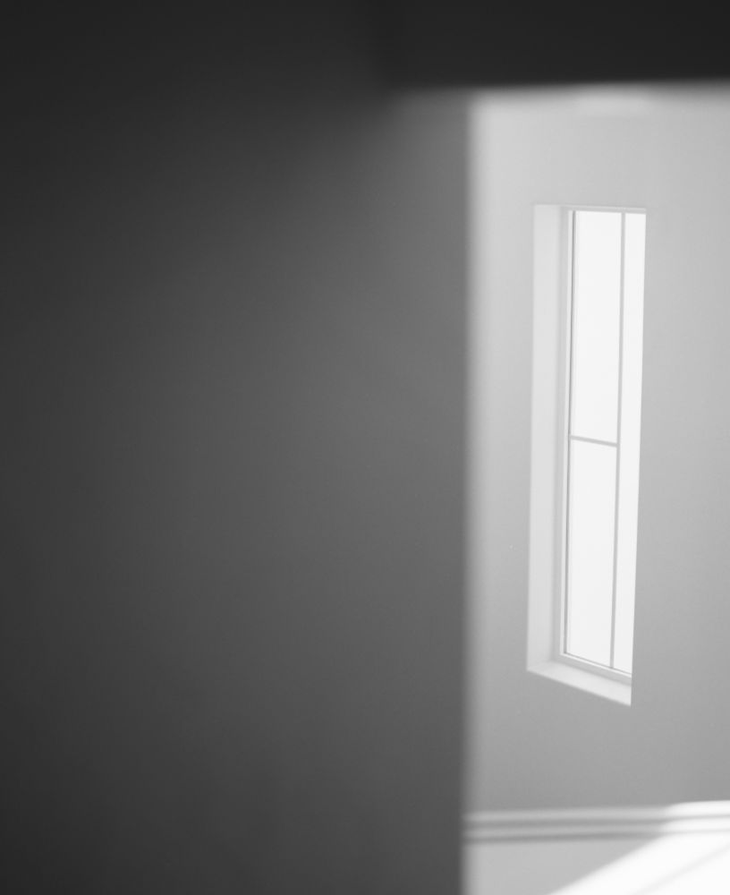 A black and white image of a thin sideways window.