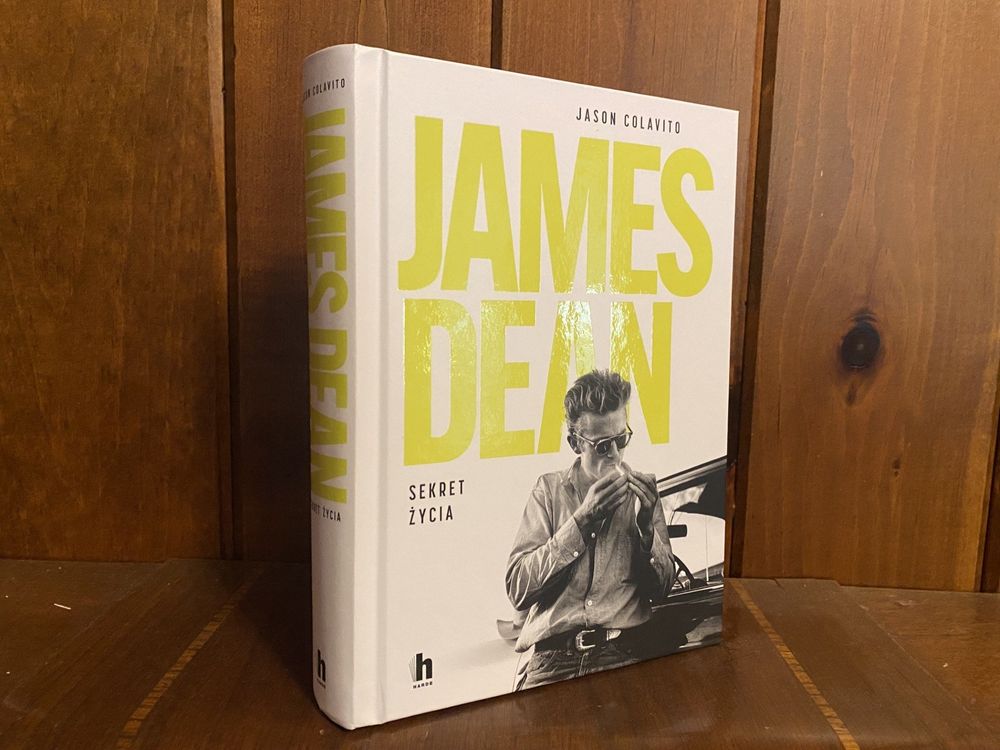 A photo of the Polish edition of my book, entitled "James Dean," standing against a wood background. 