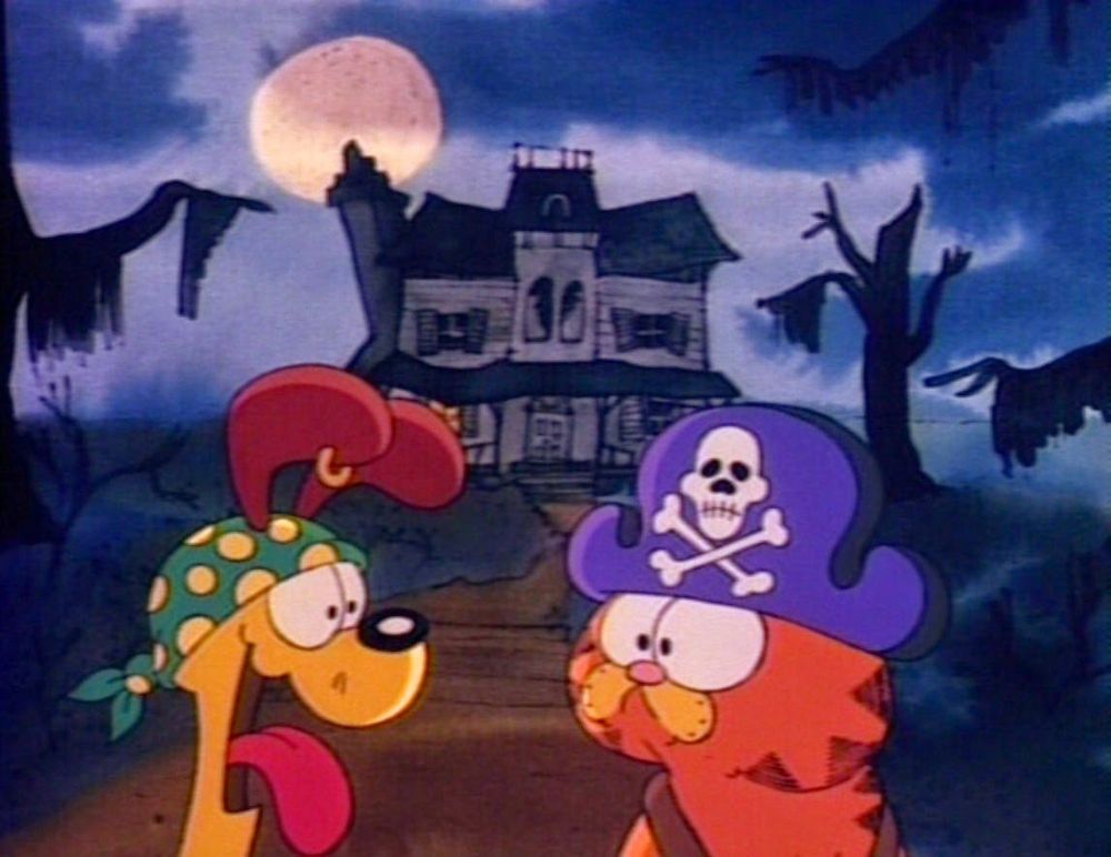 Garfield and Odie stand in front of a dilapidated mansion in a screenshot from "Garfield's Halloween Adventure" (1985).