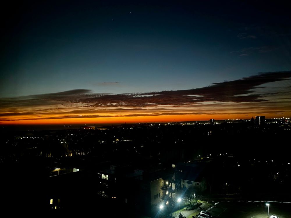An orange glow on the horizon as seen from floor 7 of The Sir Duncan Rice Library.