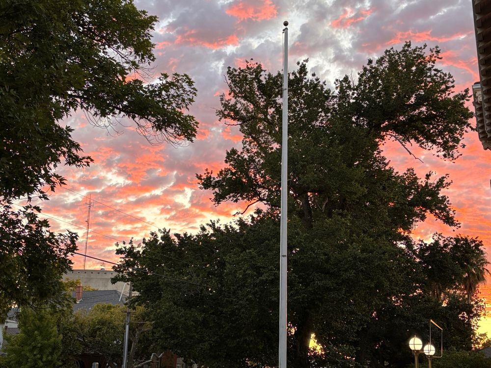 Setting sun bounces of clouds for a very pink affect with all the exciting accoutrements like trees, a water tower, and various electrical bits also in the shot. 