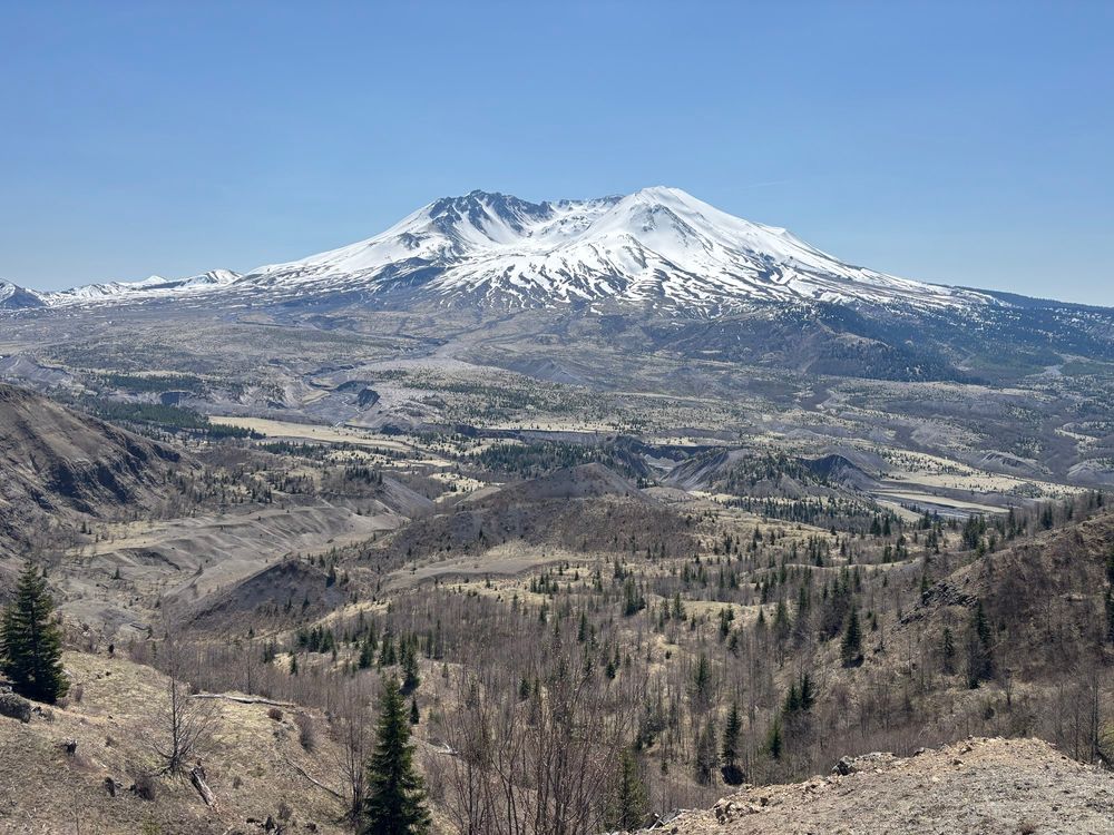 Photo looking south into the crater of Mt. St. Helens with snow melted at lower elevations in the devastated area. 