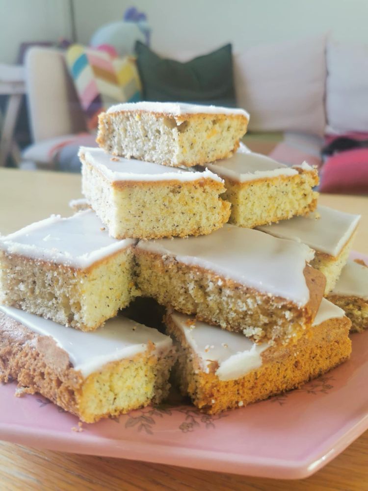 a plate heaped with slices of lemon and poppyseed cake