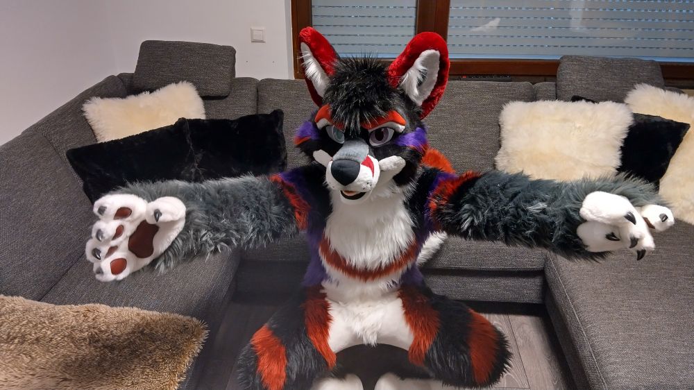 Furonimus fursuit spreading his arms out for a hug