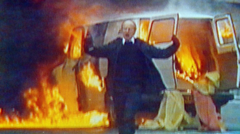 Peter Gurney, the bomb disposal operator, who has died at 93, walking away from a van that has exploded, calmly telling people to clear an area. 