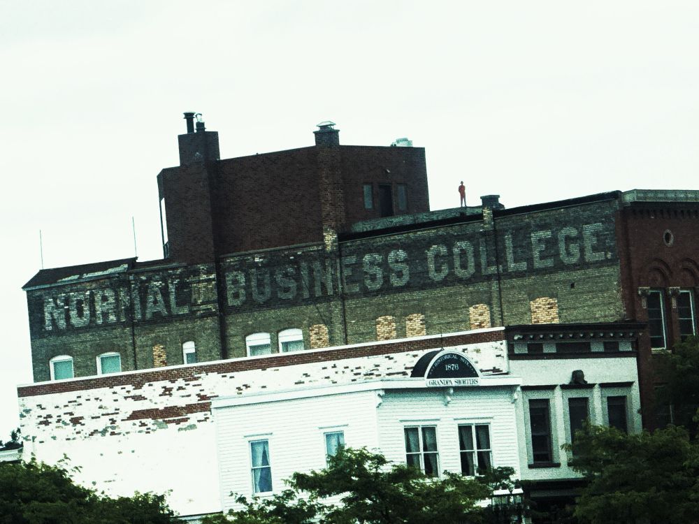 an old brick building in petoskey, mi  with the words normal business college