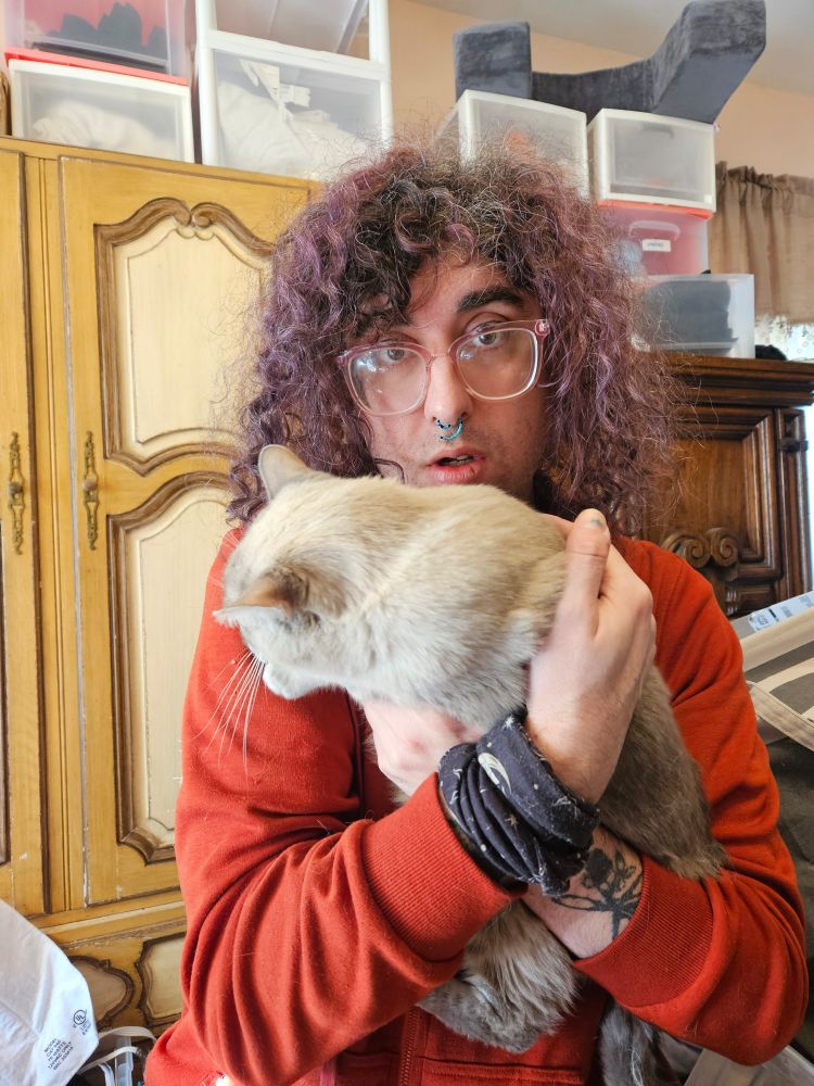An absolute snack holding the world's fastest cat.