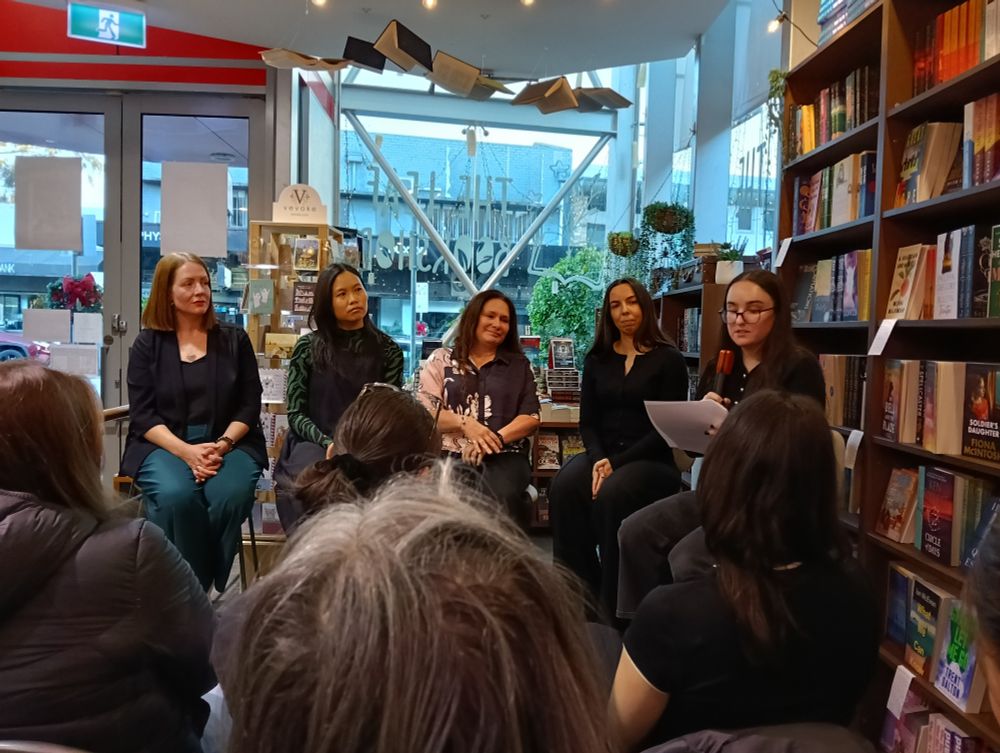 Over the heads of the crowd, sits a panel of authors: Kerryn Mayne, Grace Chan, S.K. Stapar and Holly Cardamone.