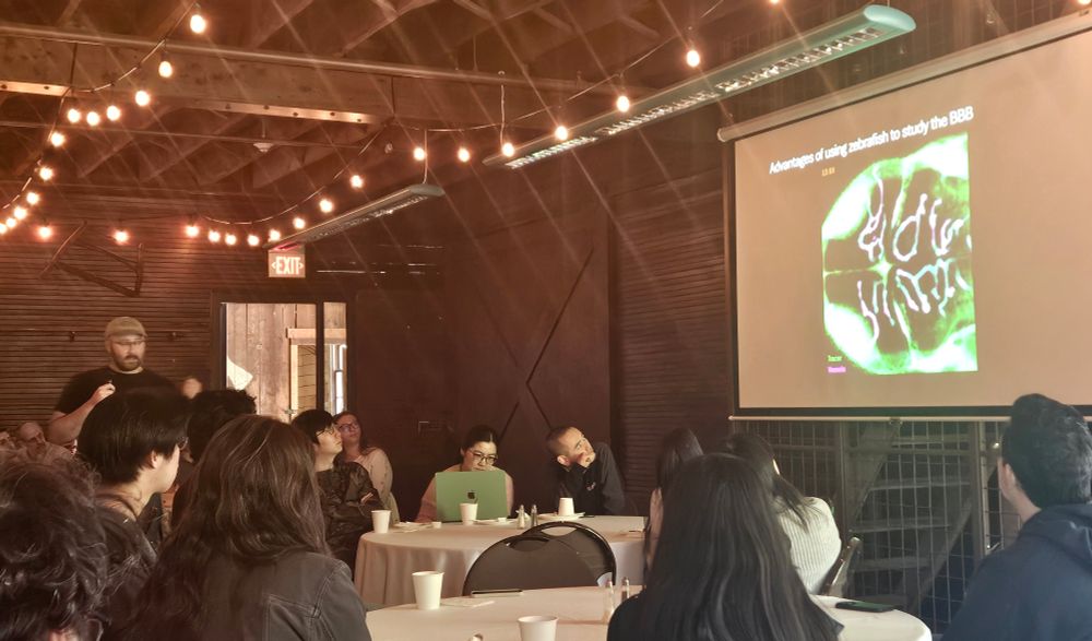 Tom is standing on the left of the barn giving a talk about the zebrafish bbb