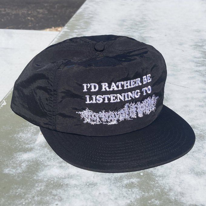 Black baseball cap with the text I’d rather be listening to Portrayal of Guilt. The Portrayal of Guilt logo is more illegible than it usually is.