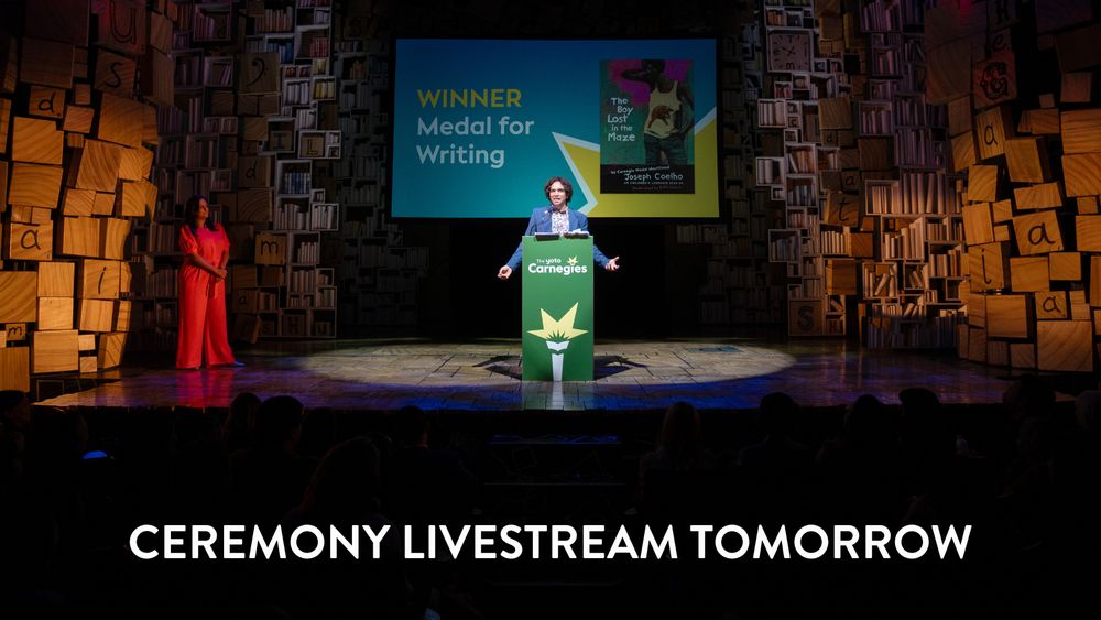 Set of matilda the musical with presenter at Carnegies awards. Copy reads Ceremony livestream tomorrow