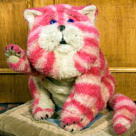 A picture of Bagpuss waving. A big fluffy stripey pink and white cat.