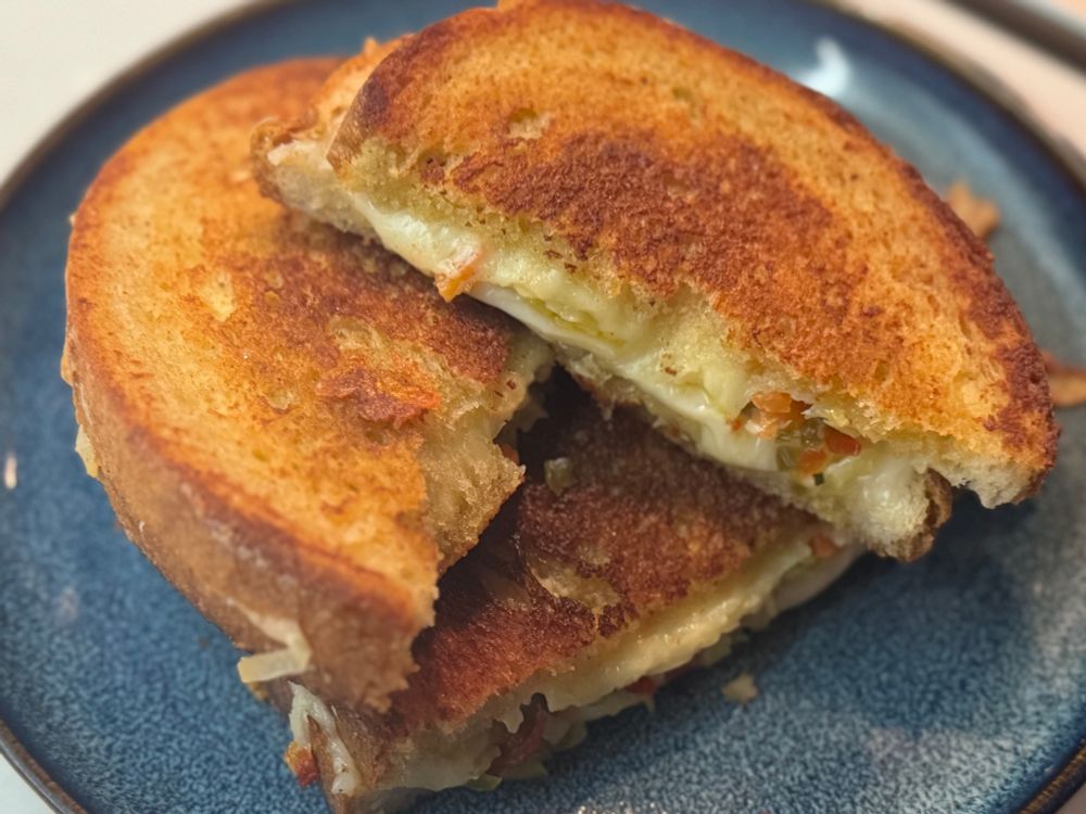 A very VERY sexy grilled cheese made with 
Manchego, smoked Gouda and Swiss, hot muffuletta on a very light rye sandwich loaf and Kewpie mayo 