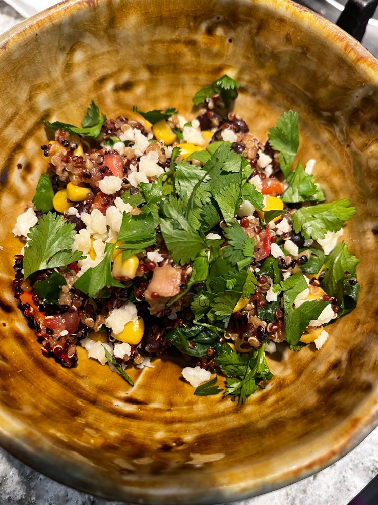 The same bowl of quinoa salad, this time topped with cotija cheese and cilantro.