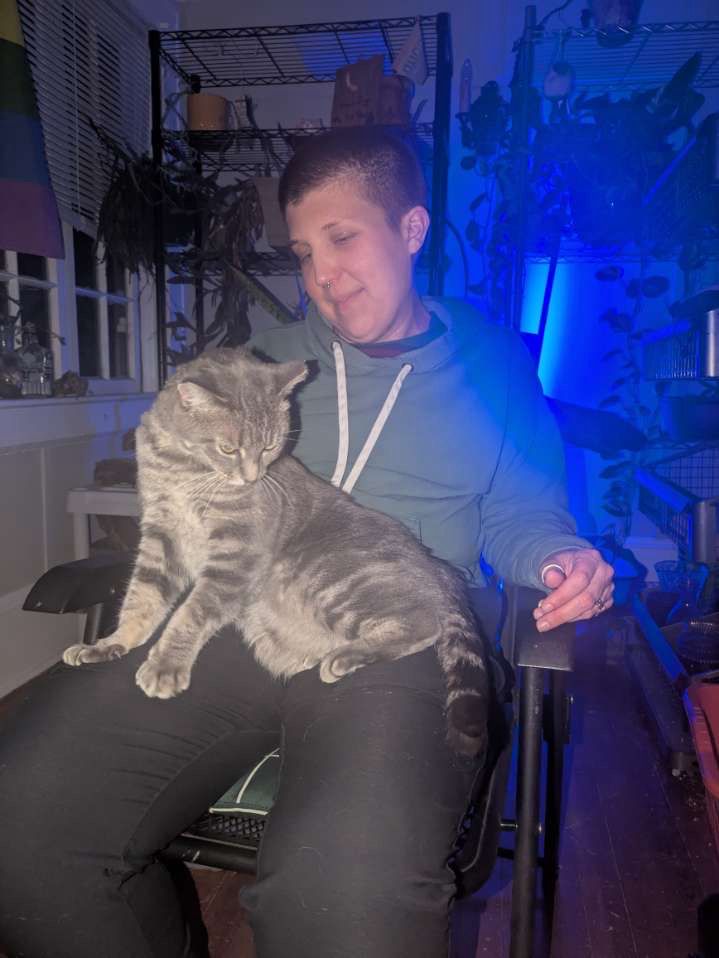 Kris and Surfer sitting together. Surfer is on Kris’ lap and they look content