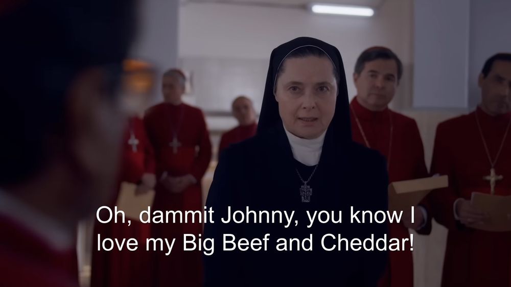 A screenshot of Isabella Rossellini's character in Conclave (2024) with the subtitle "Oh, dammit Johnny, you know I love my big Beef and Cheddar!"