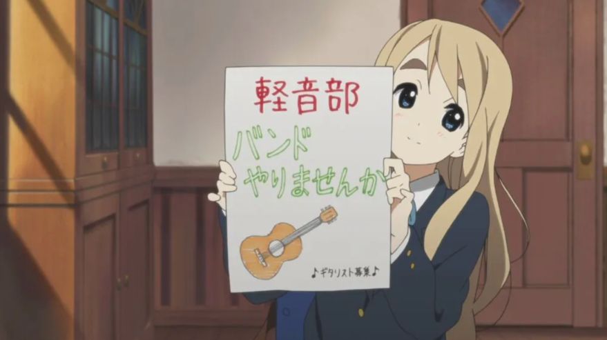 Mugi holding the light music club ad