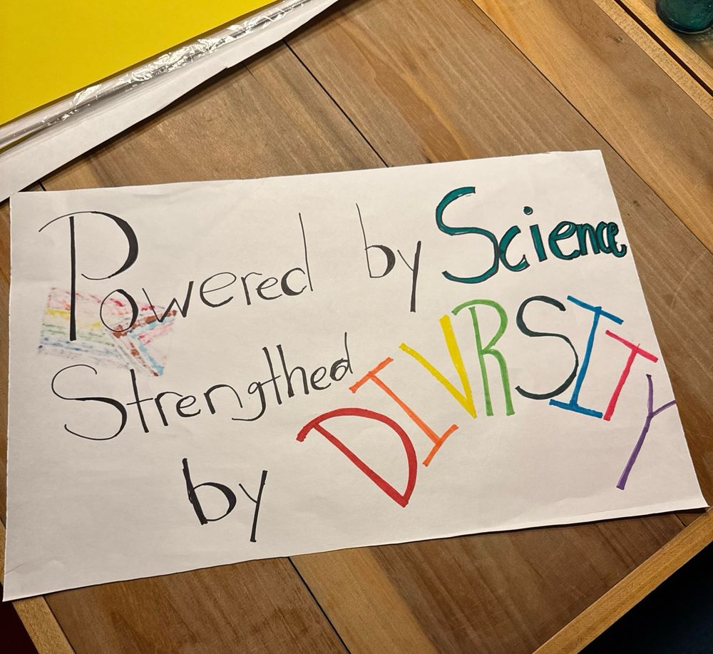 A sign reads Powered by Science Strengthened by Diversity