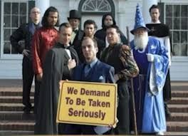 The Alliance of Magicians from Arrested Development. Gob Bluth is holding a sign saying "We demand to be taken seriously"
