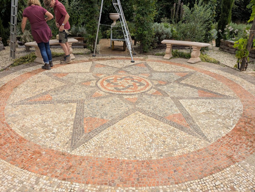 Outdoor mosaic under a pergola
