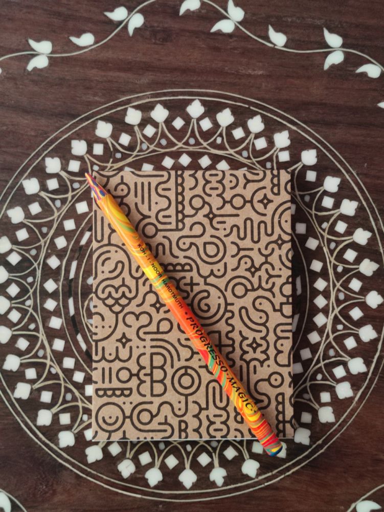 Palm-sized sketchbook and Koh-i-Noor Hardtmuth Progresso Magic pencil.