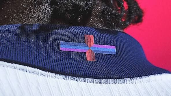  The new England mens football shirt with what Nike calls a "playful update" to the St George's Cross, consisting of triple lines of different shades of blue and pury