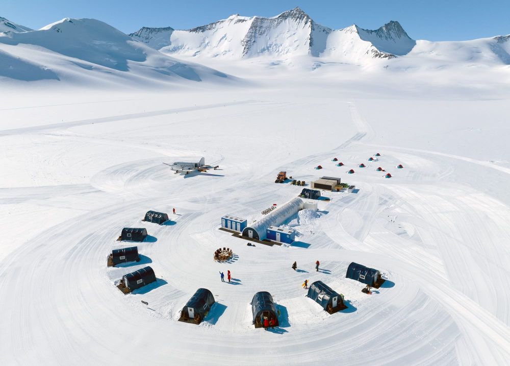 Three Glaciers Camp
Three Glaciers Camp in the deep field of Antarctica, with a Basler BT-67 aircraft parked on the snow runway. This remote outpost, nestled amid towering peaks and endless ice, supports scientific and exploratory missions as part of the 2023 Union Glacier expedition.
Photo by Christopher Michel.

