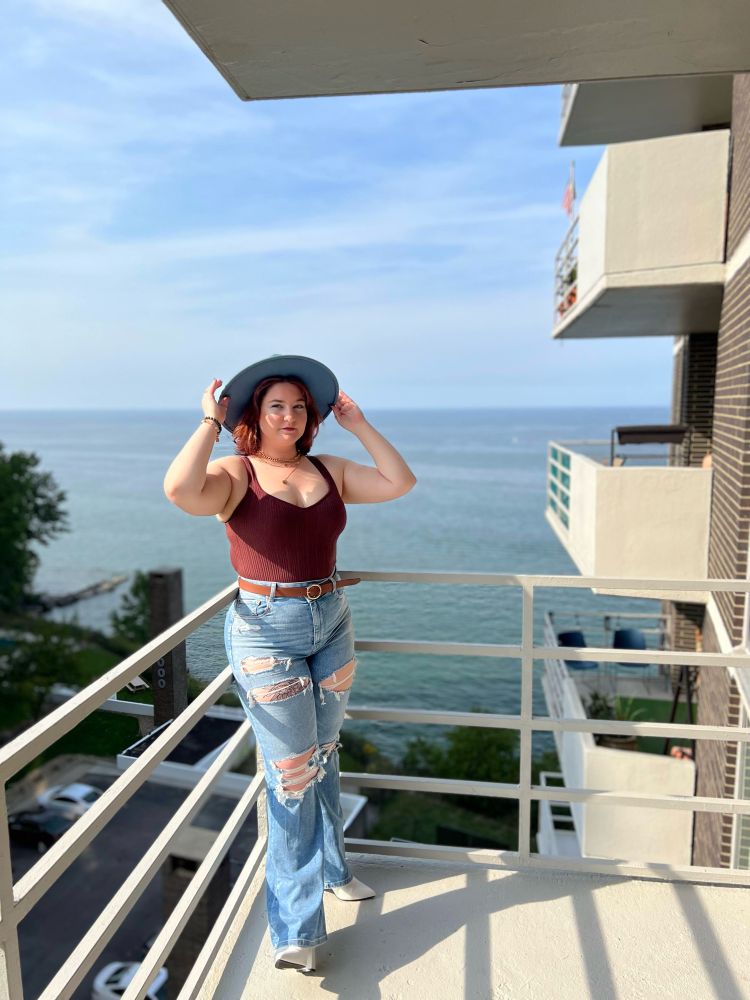 me on a balcony in a teal wide brim hat