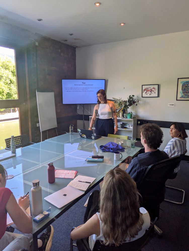 Sarah Williams delivering a presentation to the roaming reporters