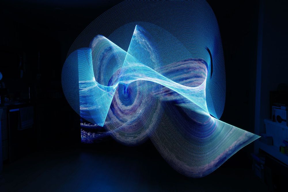 photo of spinning wavy blue LED lines produced by a light painting tool