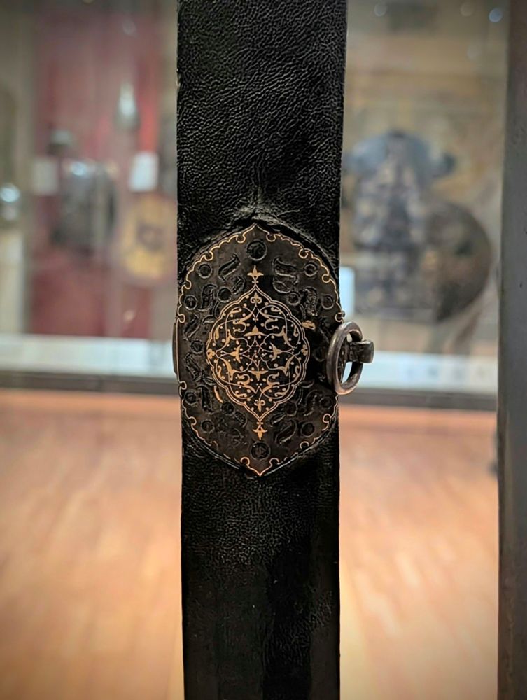 A scabbard mounting with inlays. 